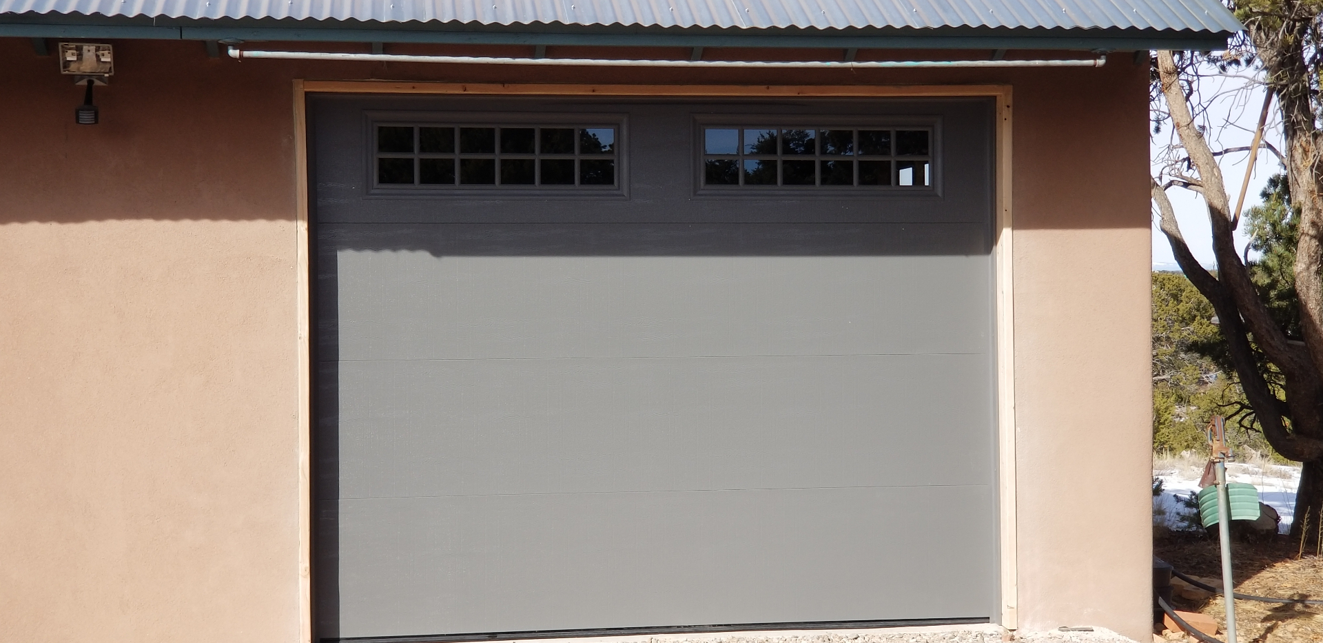New custom garage door installed by Legendary Doors on a Santa Fe adobe home